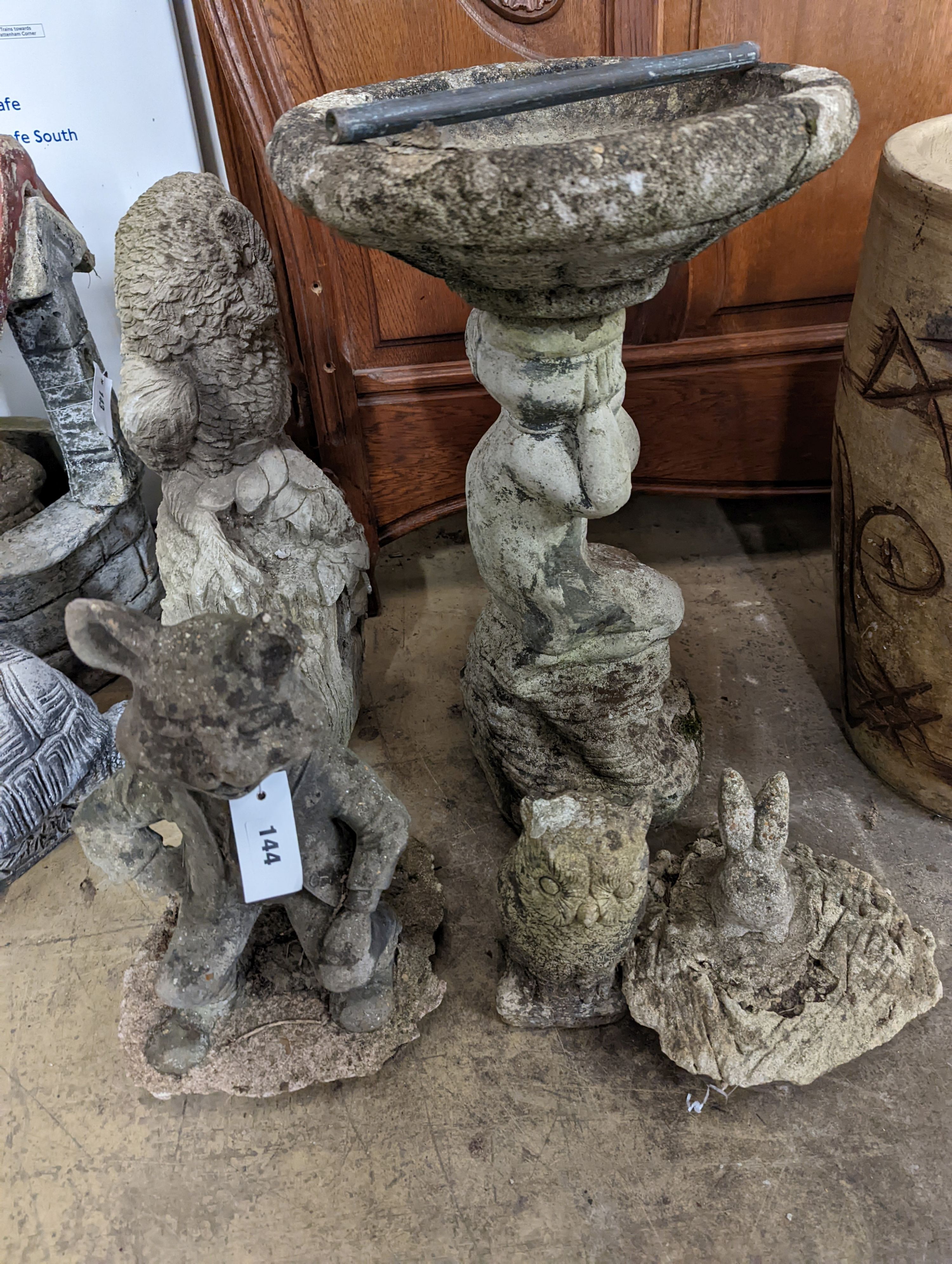 A reconstituted stone garden bird bath, height 59cm, together with four stone garden ornaments